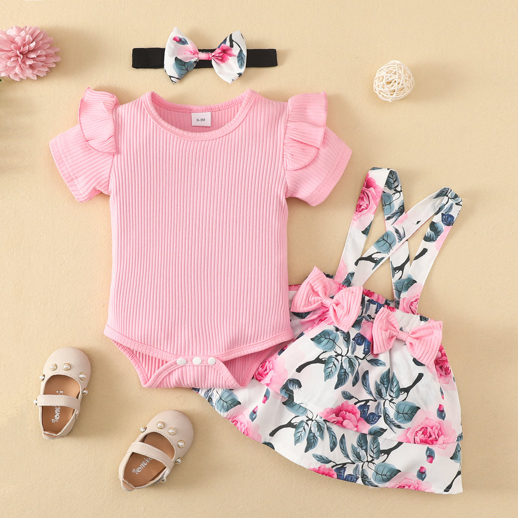 Body acanalado rosa y pollera con tirante  de flores con vincha
