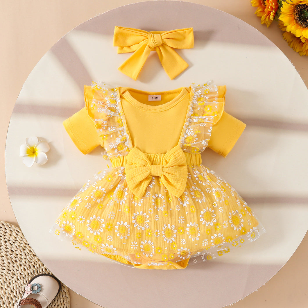 Body liso amarillo con jardinera de tul con flores y vincha