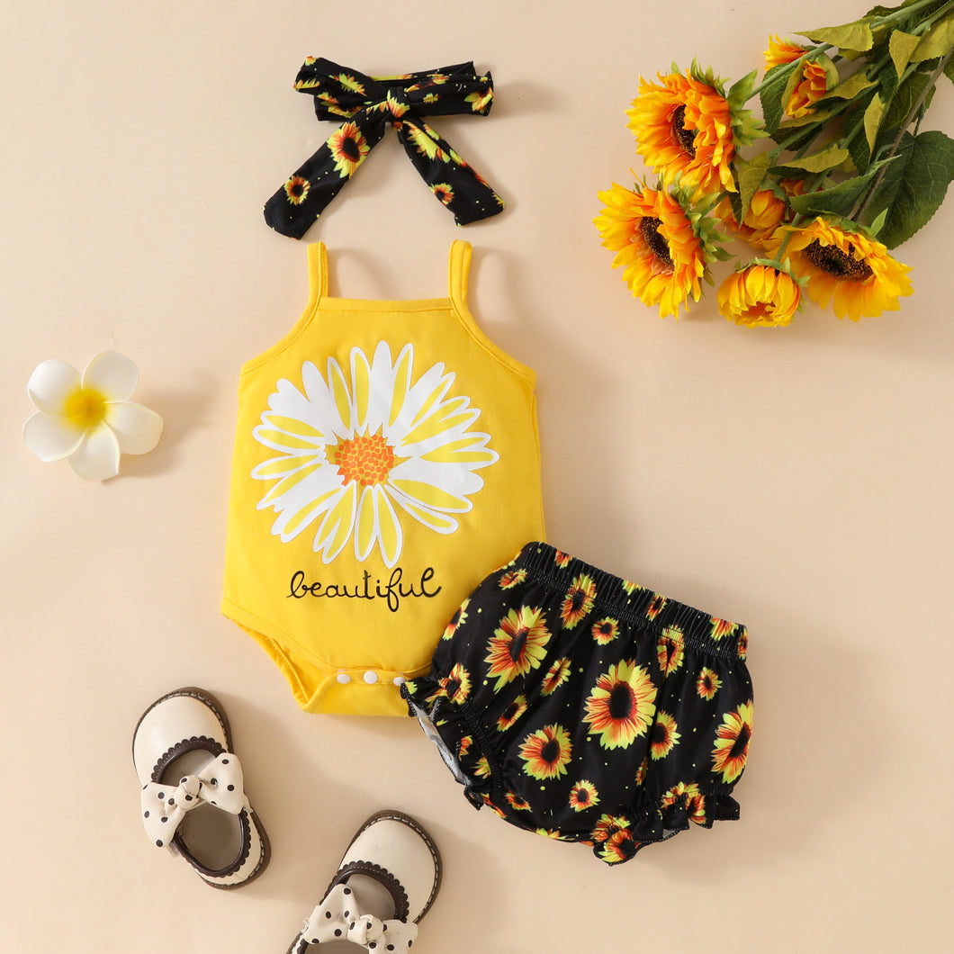 Body amarillo, short negro con estampas de girasol y vincha