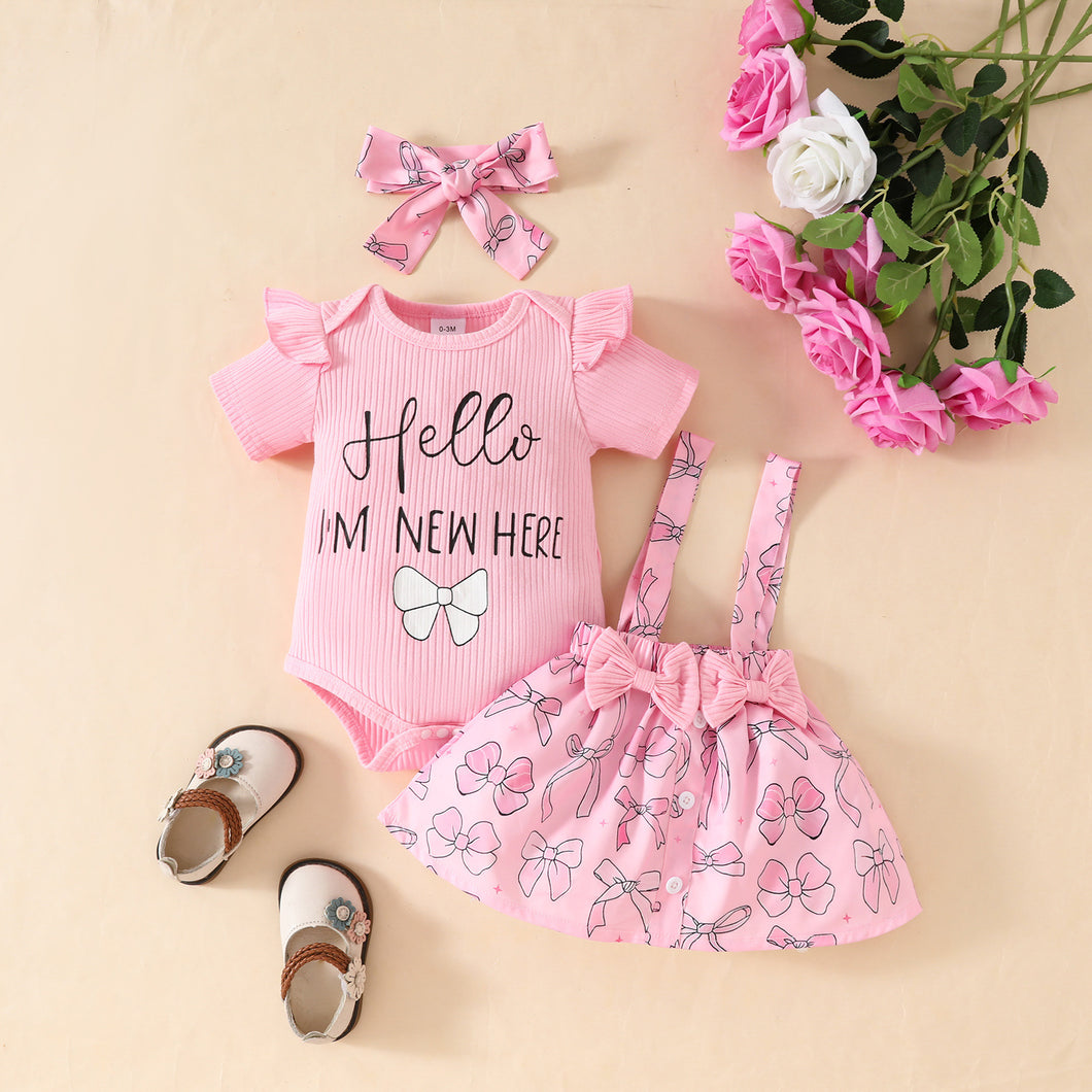 Body rosa, pollera con tirante de moños y vincha