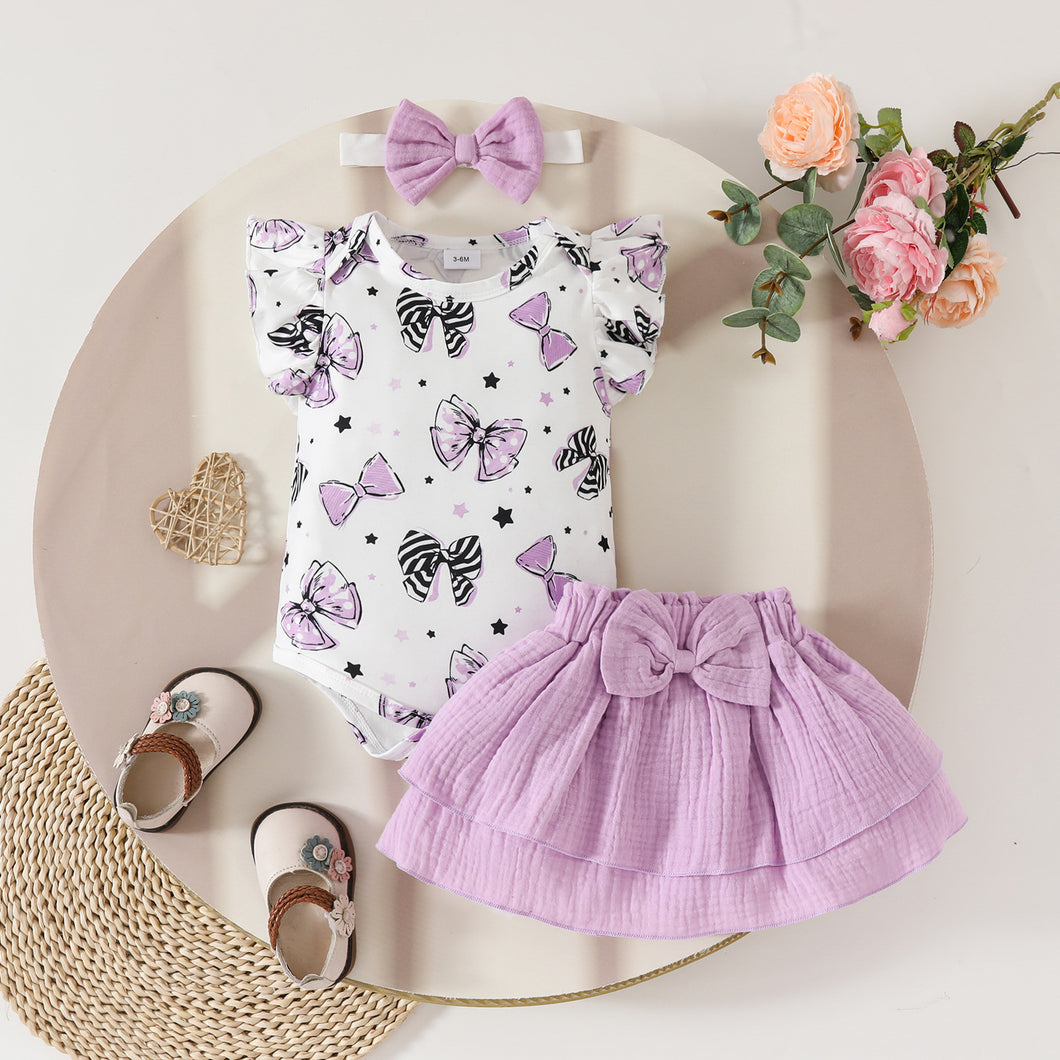 Body blanco de moños y pollera escalonado lila con vincha