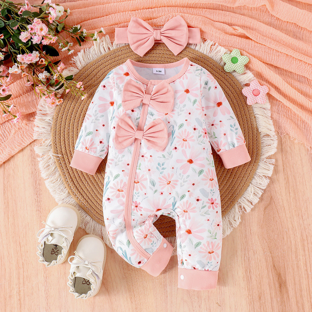 Body enterizo blanco con estampas de flores, moño y vincha rosa