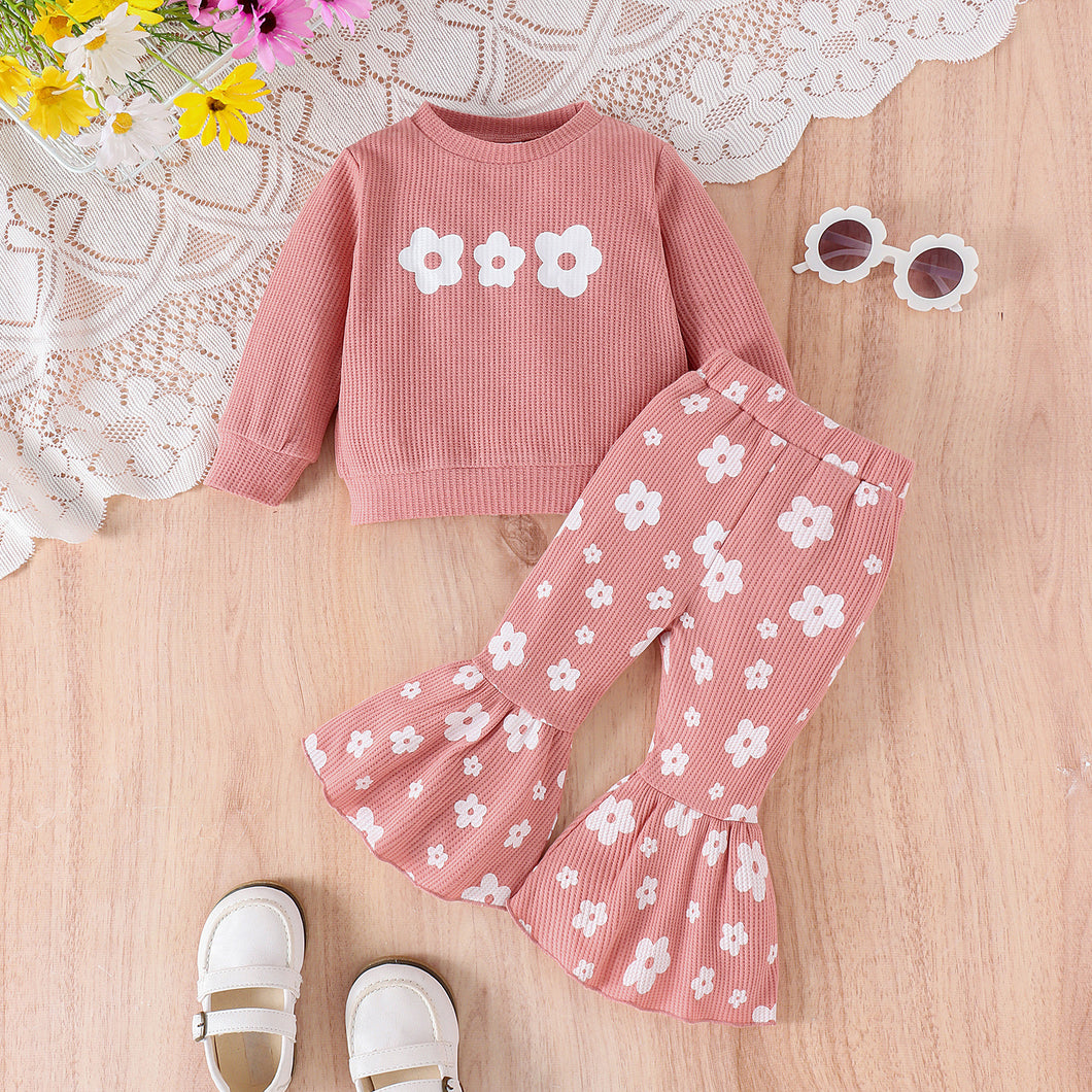 Buzo y pantalón rosa pata ancha con detalles de flores blancas