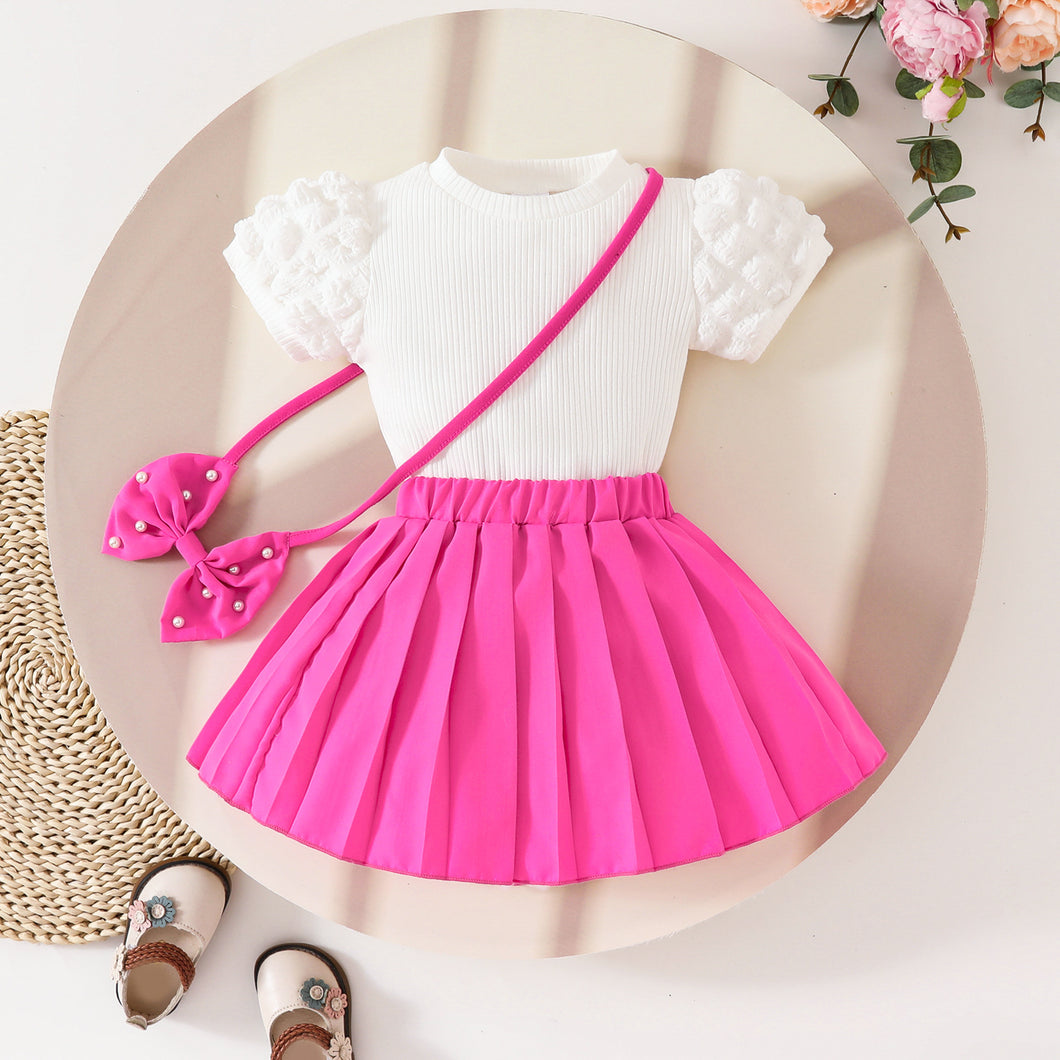 Blusa acanalado blanco y pollera pink tableado con detalle de moño