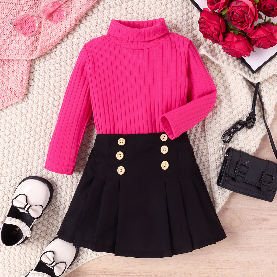 Blusa cuello alto pink y pollera negra tableada