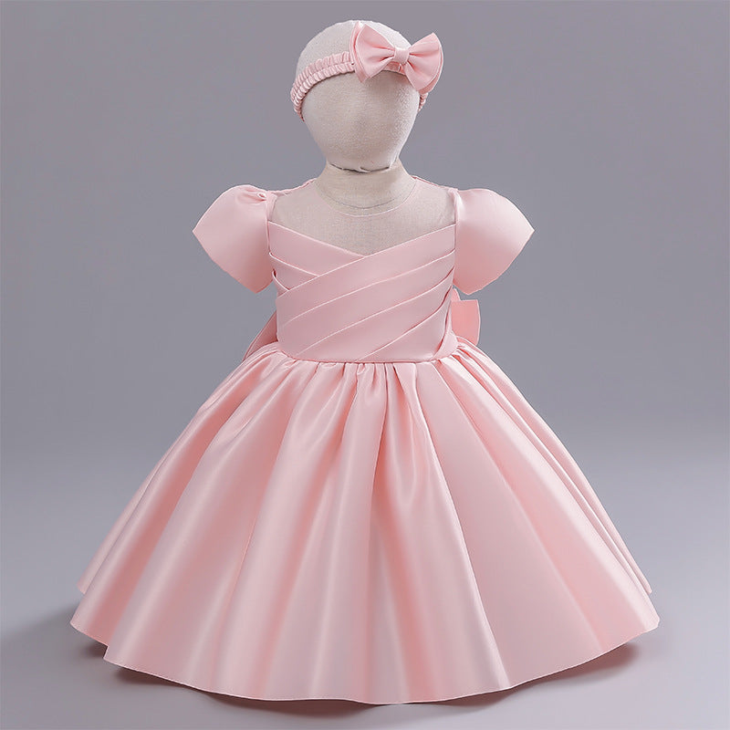 Vestido rosa liso con manga, moño y vincha