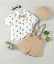 Carregar imagem no visualizador da galeria, Camisa blanco estampado de dino con short beige, tirante, moño y boina
