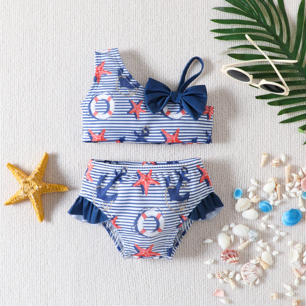 Traje de baño a rayas con estampas de anclas y estrella del mar con moño azul marino