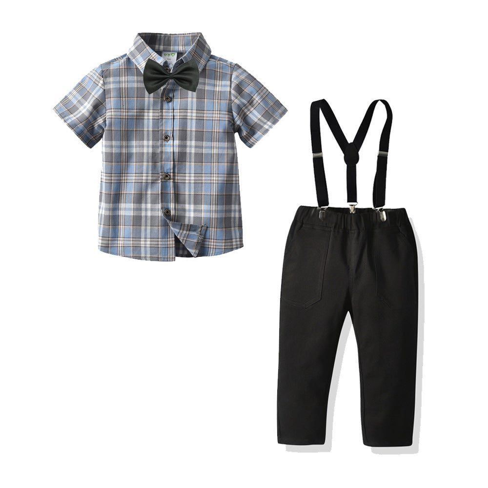 Camisa cuadrille gris, pantalón negro, tirantes, moño