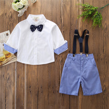 Cargar imagen en el visor de la galería, Camisa blanca manga media, moño, short azul y tirantes
